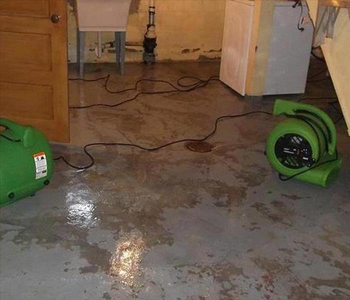 water extracted, drying concrete pad in basement with two air movers