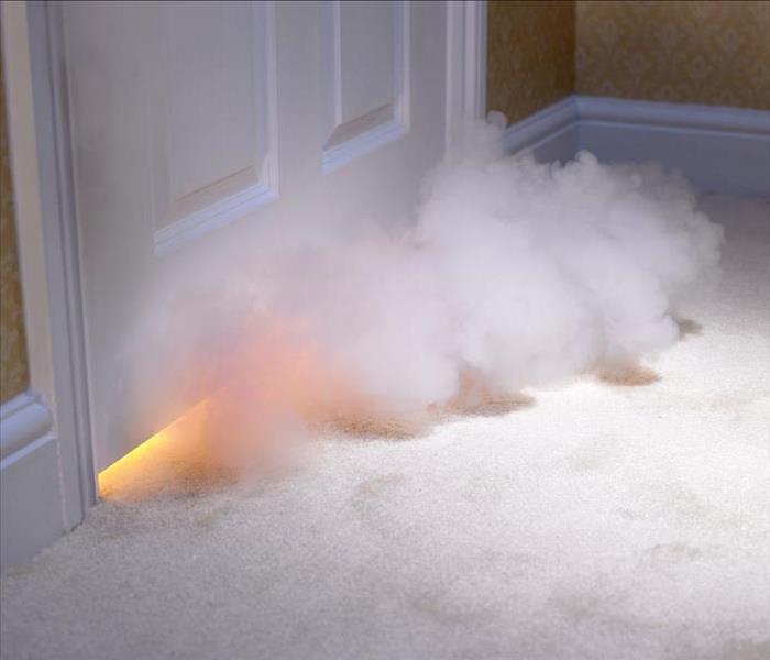 flames and smoke coming under bedroom door