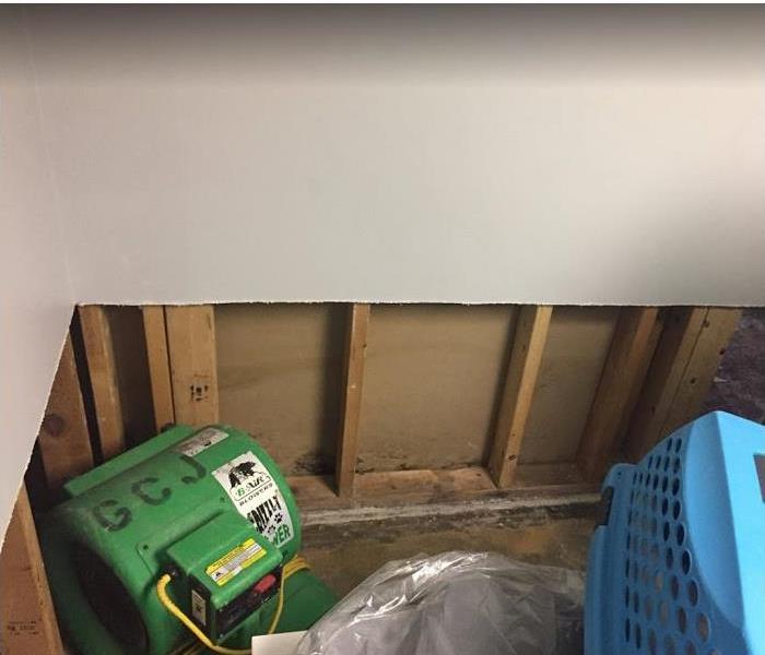 SERVPRO equipment  being used in water damaged room; flood cuts seen along walls