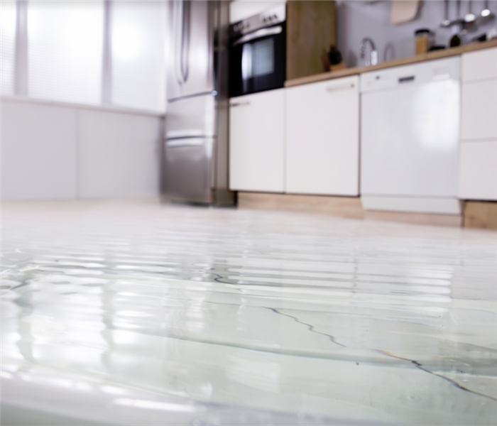 water covering tile floor in a kitchen
